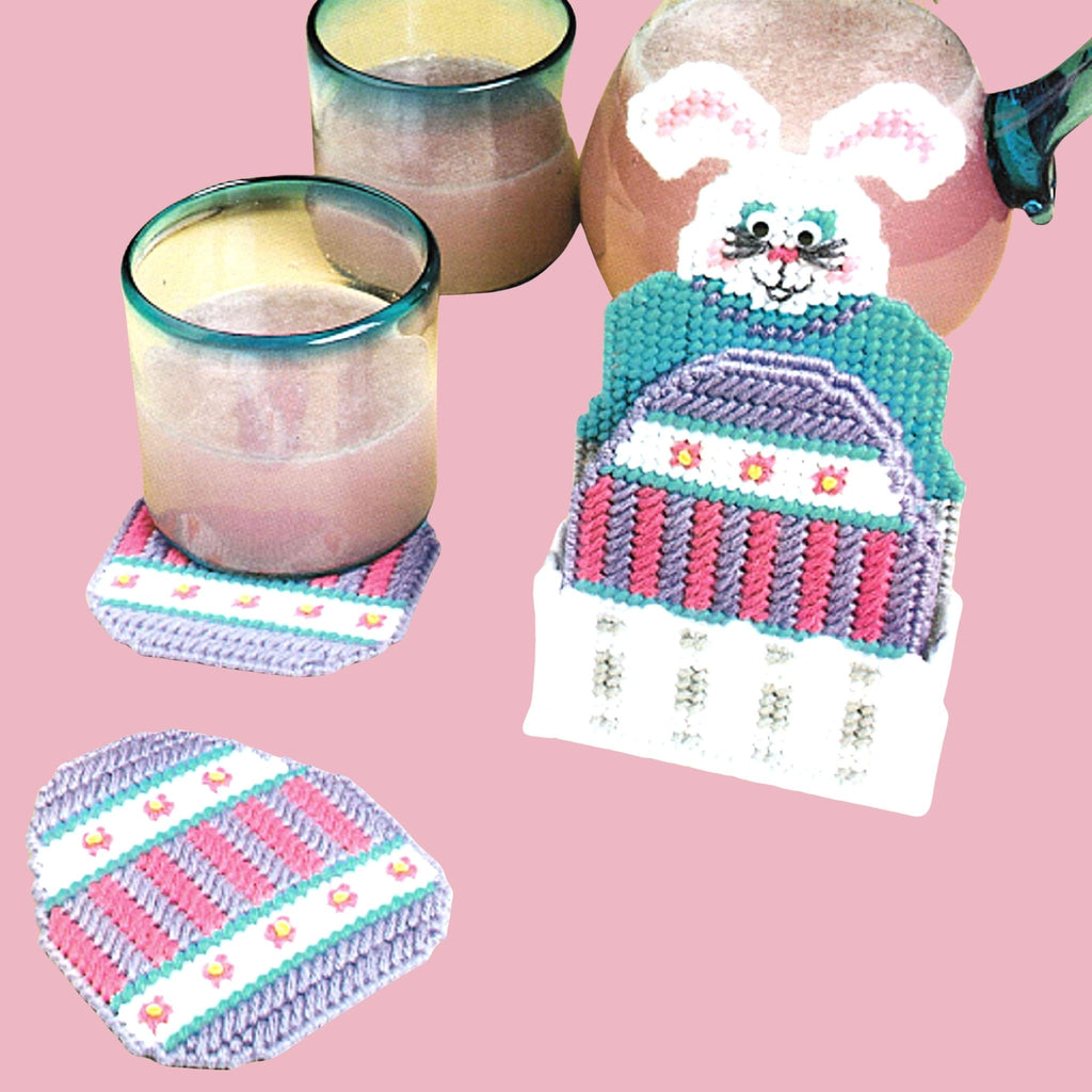 Vintage Easter Plastic Canvas Pattern: Bunny Coasters.  Four colorful Easter egg coasters sit neatly in a bunny basket, made using 7-count plastic canvas + worsted weight yarn. 
