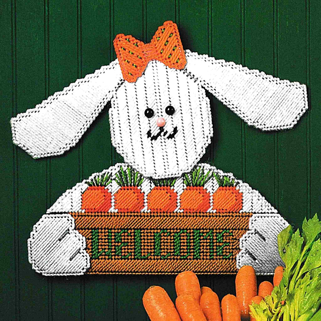 Vintage Plastic Canvas Pattern: Bunny Welcome Sign. This charming bunny rabbit with carrots offers a warm welcome to Spring or Easter guests! Basic materials you'll need are 7-count stiff plastic canvas sheets and worsted/ #4 medium-weight yarn. 