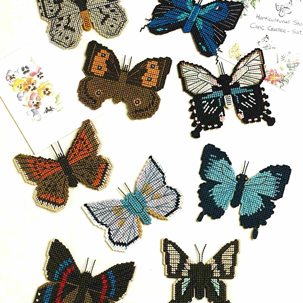 Vintage Plastic Canvas Pattern: Butterfly Magnets 01. Charts included for following butterflies: Albulina Orbitulus, Mountain Blue, Leptocircus Curius, Pearly Eye, Great Purple Hairstreak, American Copper, Common Wood Nymph, Neocyria Manco, and Papilio Memnon.  Basic materials you'll need are 10-mesh plastic canvas sheets, embroidery floss, and 3-ply yarn.