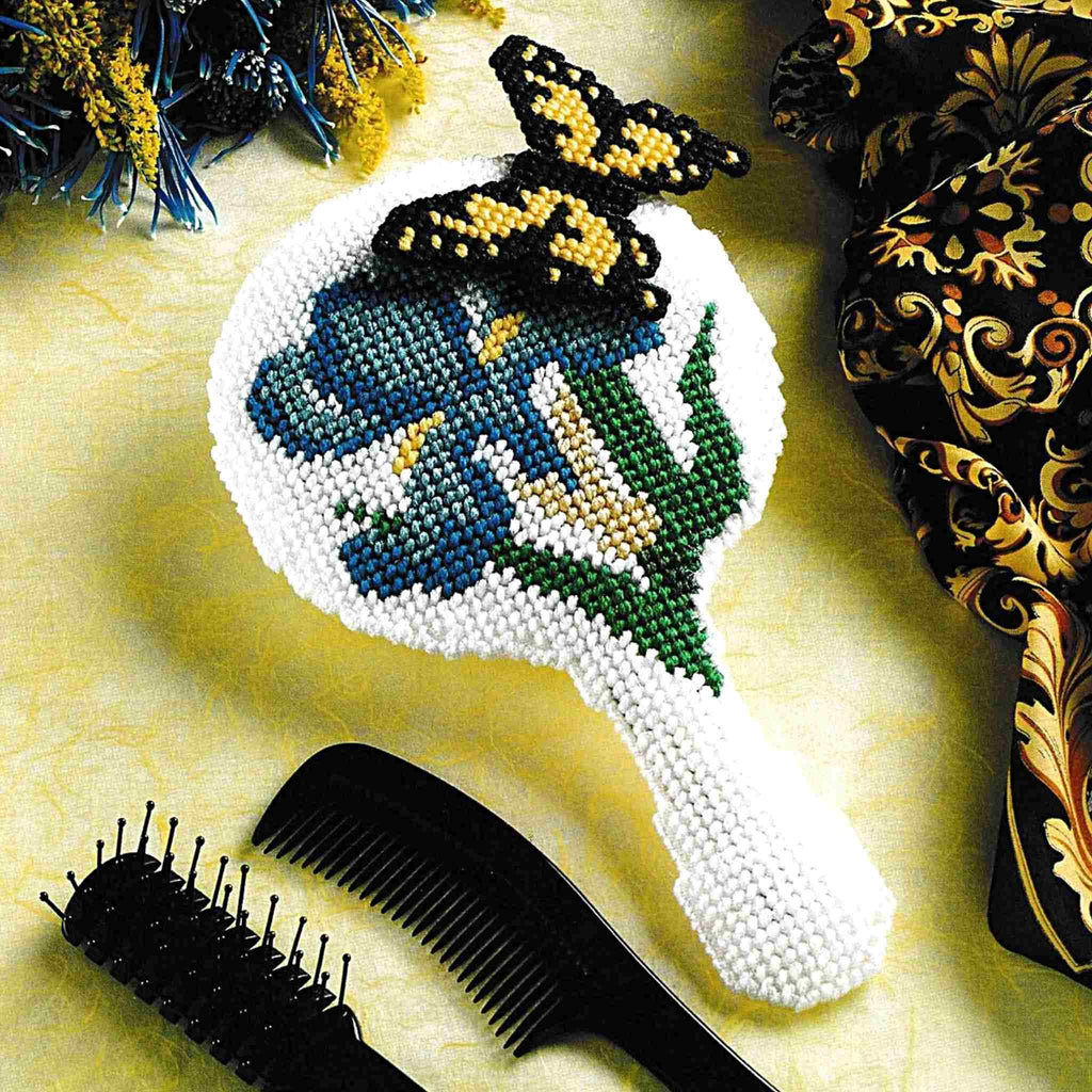Vintage Plastic Canvas Pattern: Butterfly Mirror. Iris and butterfly handheld mirror created with a 5" round craft mirror. Basic materials used are 7-count plastic canvas and worsted/ #4 medium-weight yarn. 